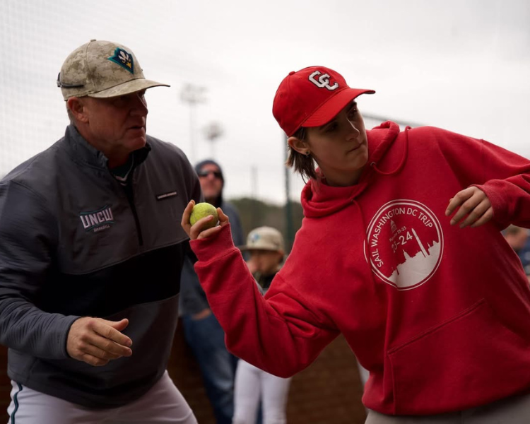 Trent Mongero instructing a teenage camper on arm angle at a dirt bros elite infield camp