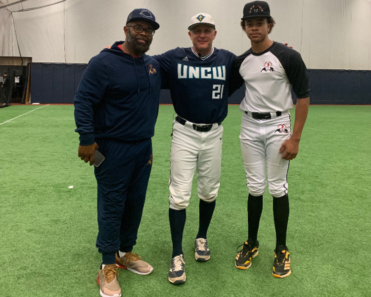 Trent Mongero and a camper with his father after a dirt bros baseball academy