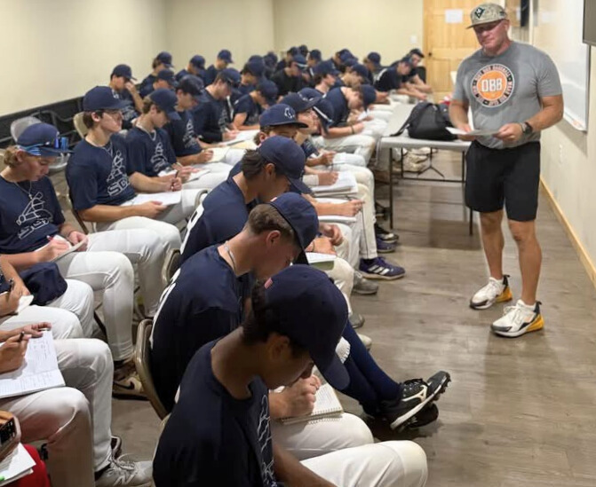 Coach Trent Mongero instructing college and high school baseball players on elite infield play.